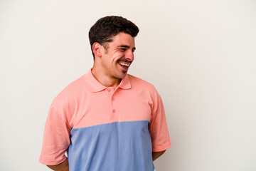 Fototapeta premium Young caucasian man isolated on white background laughs and closes eyes, feels relaxed and happy.