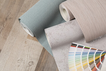 Wall paper rolls and color palette on wooden floor - obrazy, fototapety, plakaty