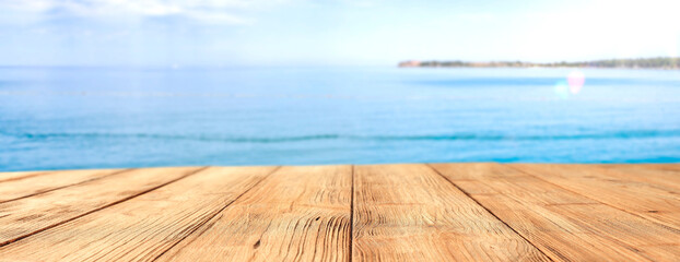 A wooden table on a beautiful sunny holiday day with a charming sea landscape 