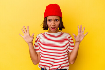 Young mixed race woman isolated on yellow background screaming to the sky, looking up, frustrated.