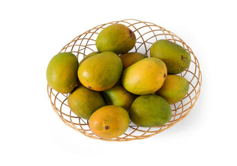 indian mangos in a basket on a white background in top view