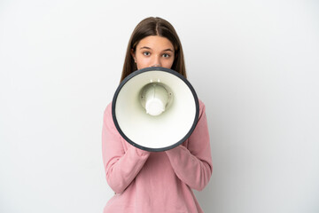 Little girl over isolated white background shouting through a megaphone to announce something
