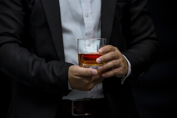Closeup businessmen holding a glass of whiskey