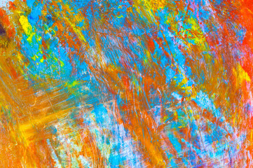 colorful creative motley background: smudged residues of oil paints on a wooden palette, short focus, selective blur
