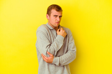 Young caucasian man isolated on yellow background