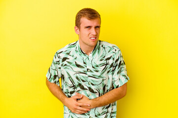 Young caucasian man isolated on yellow background