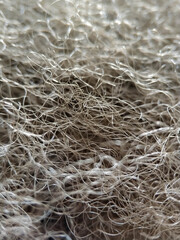 Close-up gray fibers of artificial filler. Synthetic soft wool