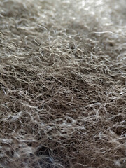Close-up gray fibers of artificial filler. Synthetic soft wool