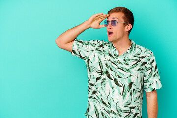 Young caucasian man wearing a summer clothes isolated on blue background