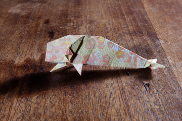 Origami whaleS over wooden background. Conceptual image.
