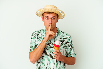 Fototapeta premium Young caucasian man wearing a summer clothes and holding a ice cream isolated on white background