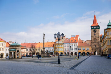 Fototapeta premium Wallenstein square, renaissance historical buildings, baroque meteorological column, gothic tower Valdice gate and Marian Column, sculptural group of Virgin Mary, Jicin, Czech Republic