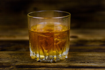 Glass of whiskey on the dark wooden background