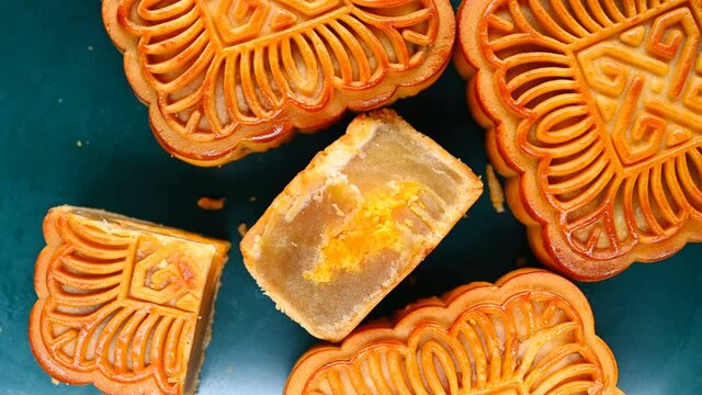 top view square shape traditional mooncakes with one piece cut out rotating