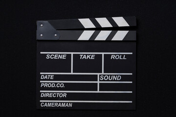 Fototapeta na wymiar movie clapper on black table background; film, cinema and video photography concept