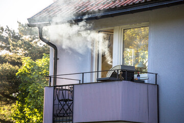 Stockholm, Sweden Smoke from a barbeque wafts up from an apartment  balcony.