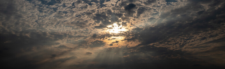 sky with dark clouds and sun light. Nature background of sky