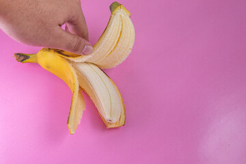 Banana on the pink background - man holding