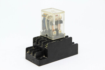 An electrical auxiliary relay in transparent plastic cases on white background.