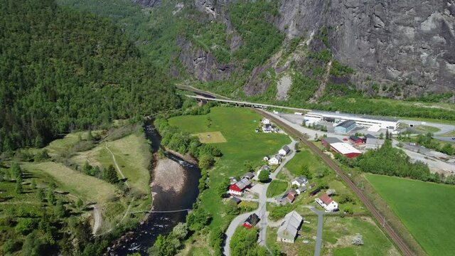 Dale river Bergensbanen railway and road E16 close by - Beautiful summer day aerial overview of river and Dalegarden industry area - Dale Vaksdal Norway