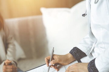 Close-up of woman-doctor and patient discussing current health examination while sitting indoors. Stay at home concept during Coronavirus pandemic and self isolation quarantine. Covid 2019