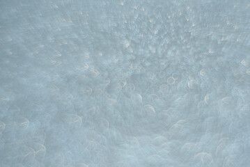 Defocused grey or silver background with blurred interesting bokeh. Abstract background