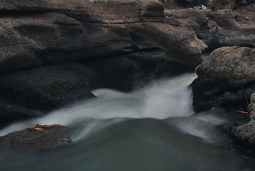Opak River. Swift stream of iver with exotic rock beside