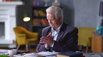 Fototapeta premium Senior businessman doing paperwork at home office