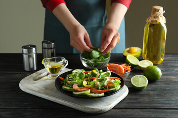 Concept of cooking shrimp salad on wooden table