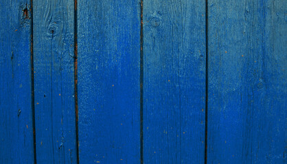 Wooden boards painted in blue. Rough and cracked surface. Old wood and paint.Background and texture.