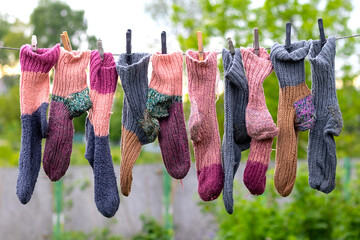 Knitted washed socks dry on a clothesline