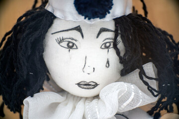The face of a sad Pierrot doll
