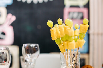 Catering, close up set of festive appetizing fruits canapes, healthy snacks on banquet, party dining