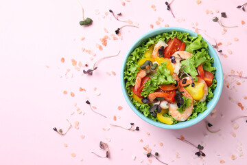 Concept of tasty eating with shrimp salad on pink background