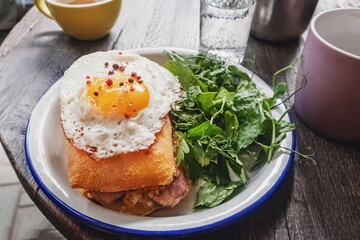 Sandwich with ham and fried egg on the top