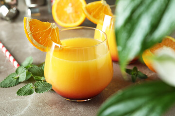 Tequila sunrise cocktails on gray textured table, close up