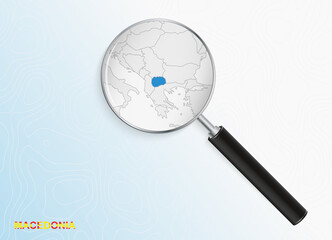Magnifier with map of Macedonia on abstract topographic background.