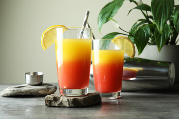Tequila Sunrise cocktails on gray textured table