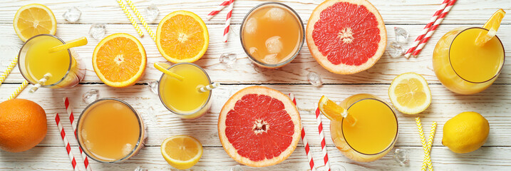 Tequila sunrise cocktail and ingredients on wooden table