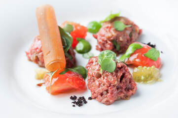 Appetizer on a plate of fresh tomatoes
