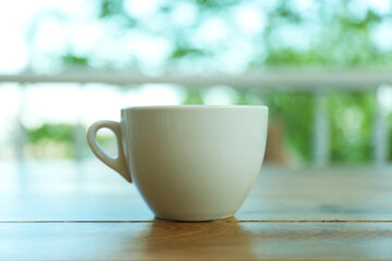 Cup of coffee on wooden table in restaurant