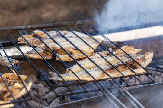 Delicious sea bass and golden fish barbecued on the charcoal