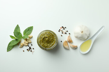 Pesto sauce and ingredients on white background