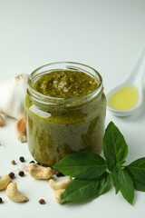 Pesto sauce and ingredients on white background