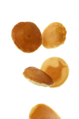 Tasty falling pancakes isolated on white background