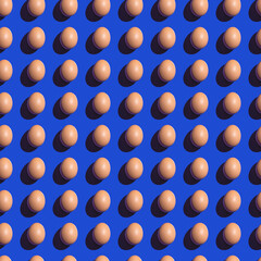 Seamless texture background pattern from eggs on a colored background. Minimal food concept.