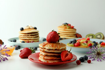 Concept of delicious dessert with pancakes on white table