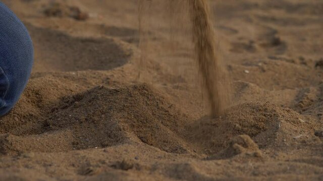 Beach sand falling from hands