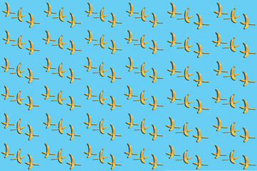 Colorful fruit peeled banana patterns on a blue background