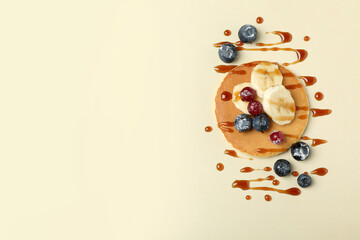 Concept of tasty food with pancake on beige background